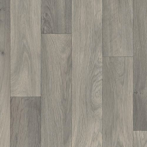 A close-up view of a gray wooden plank floor with varied shades and natural grain patterns.