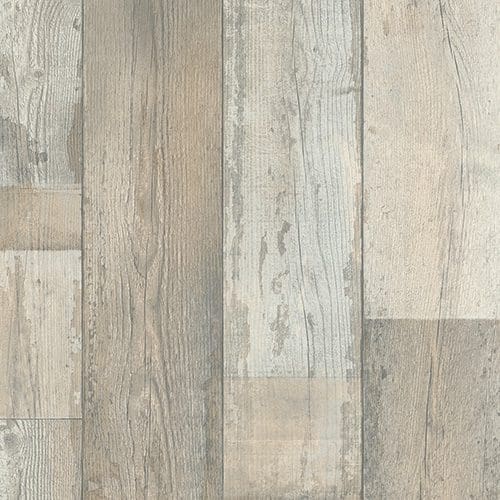 Close-up view of a wooden floor with various shades and textures of gray and beige planks arranged in a random pattern.