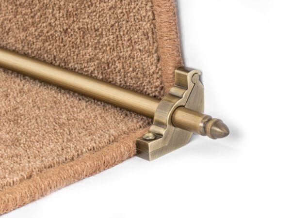 Close-up of Stair Rods - Homepride with decorative brackets holding down the edge of a brown carpet on a staircase.