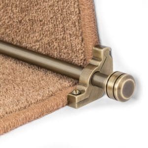 Close-up of a Stair Rods - Vision Piston securing a beige carpet runner on a step.