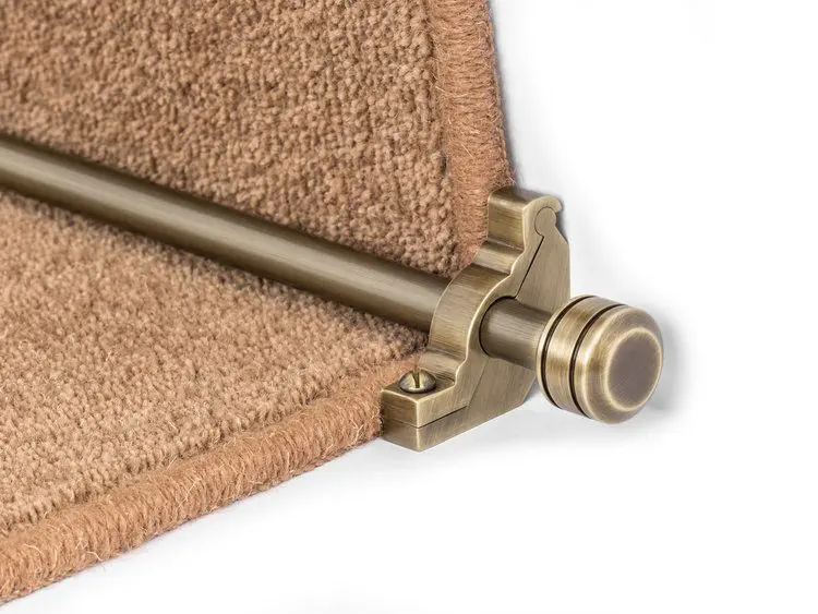 Close-up of a Stair Rods - Vision Piston securing a beige carpet runner on a step.