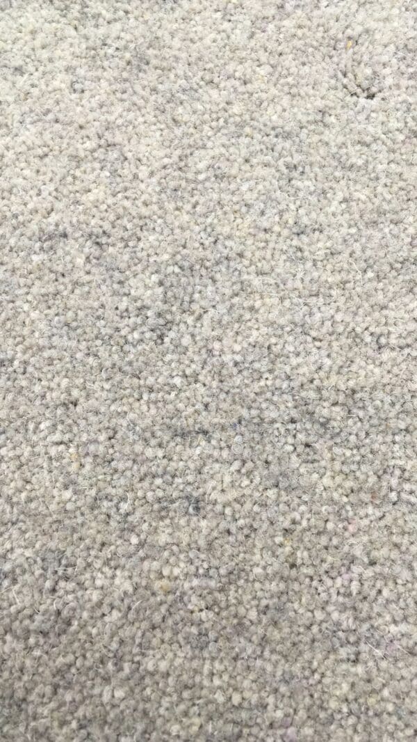 Close-up view of a Buckingham 50 2018 wool carpet with a textured, looped pile and an action back.