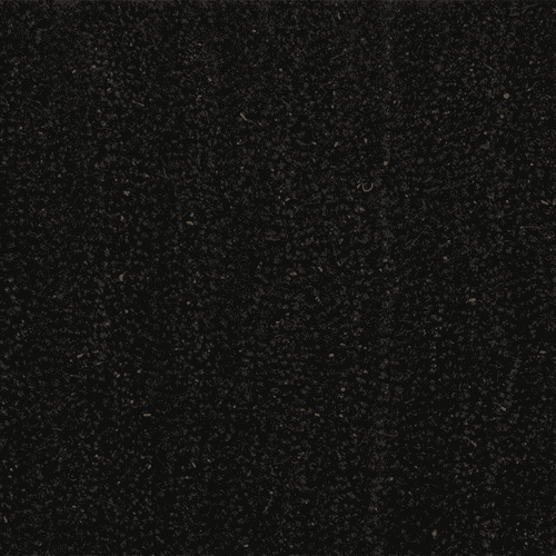 A close-up view of a black, textured surface with small, visible particles.