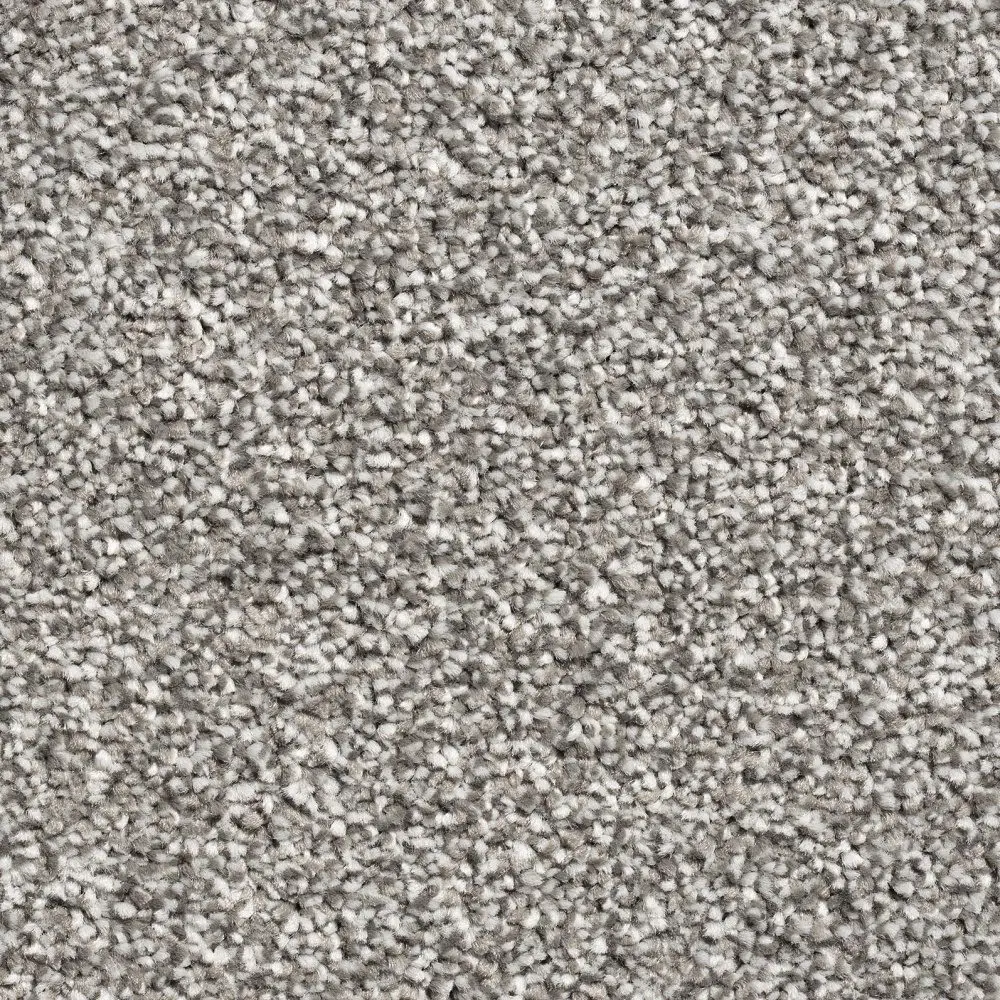 Close-up view of a light gray, high-pile carpet with a slightly textured surface, featuring Tranquil Twist and durable Action (Hessian) backing for added longevity.