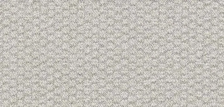 Close-up of a textured white and gray woven fabric with a repetitive zigzag pattern.