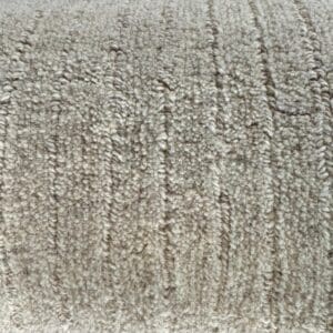 Close-up view of a Man Made Luxurious Carpet Remnant with a pattern of parallel ridges.