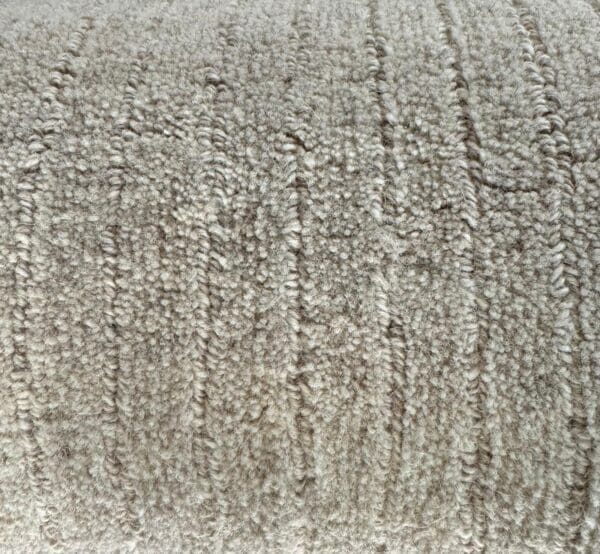 Close-up view of a Man Made Luxurious Carpet Remnant with a pattern of parallel ridges.