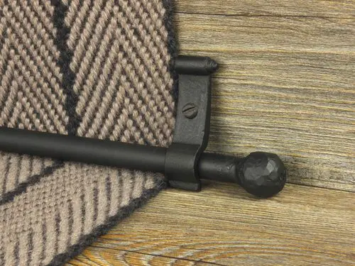 Black metal stair rod with ball finial.