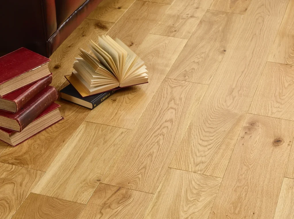 Books on wooden floor, one open.