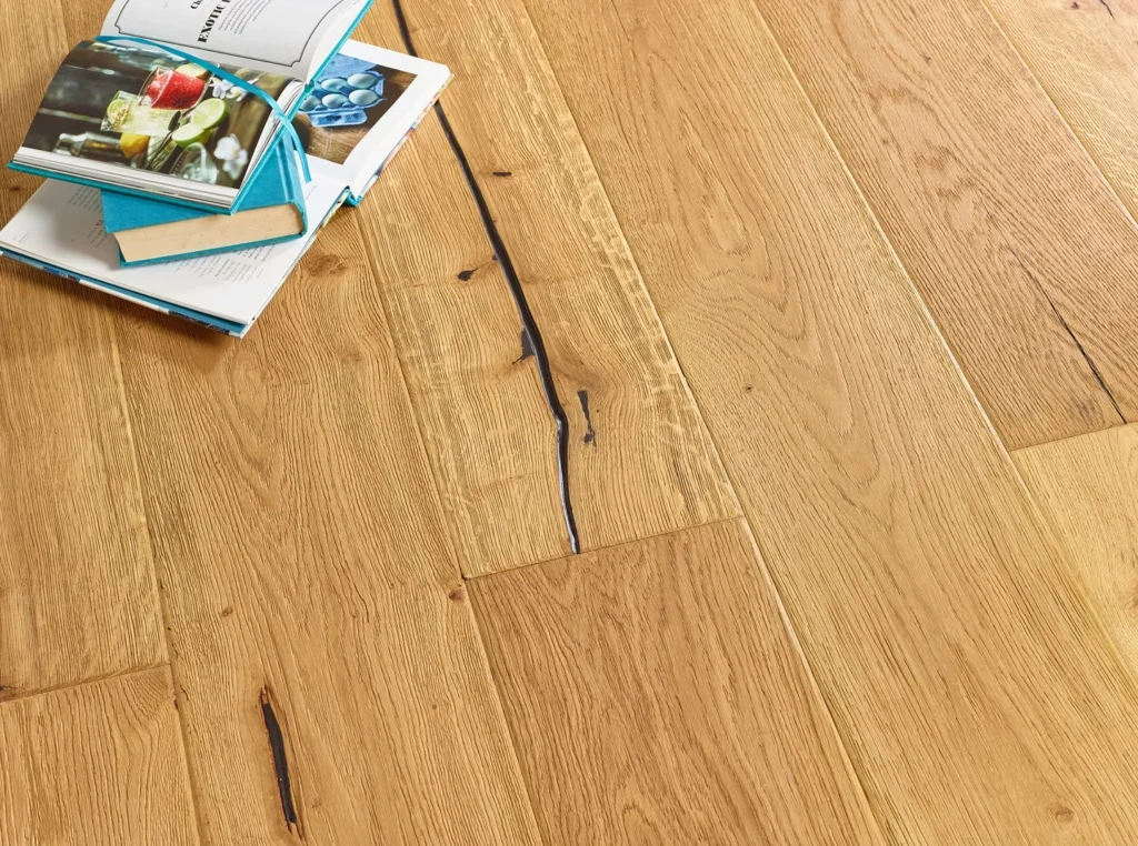 Wooden floor with books stacked nearby.