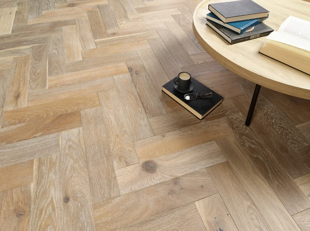 Wooden floor with round table and books.