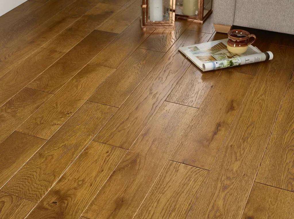 Wooden floor with candles and magazine nearby.