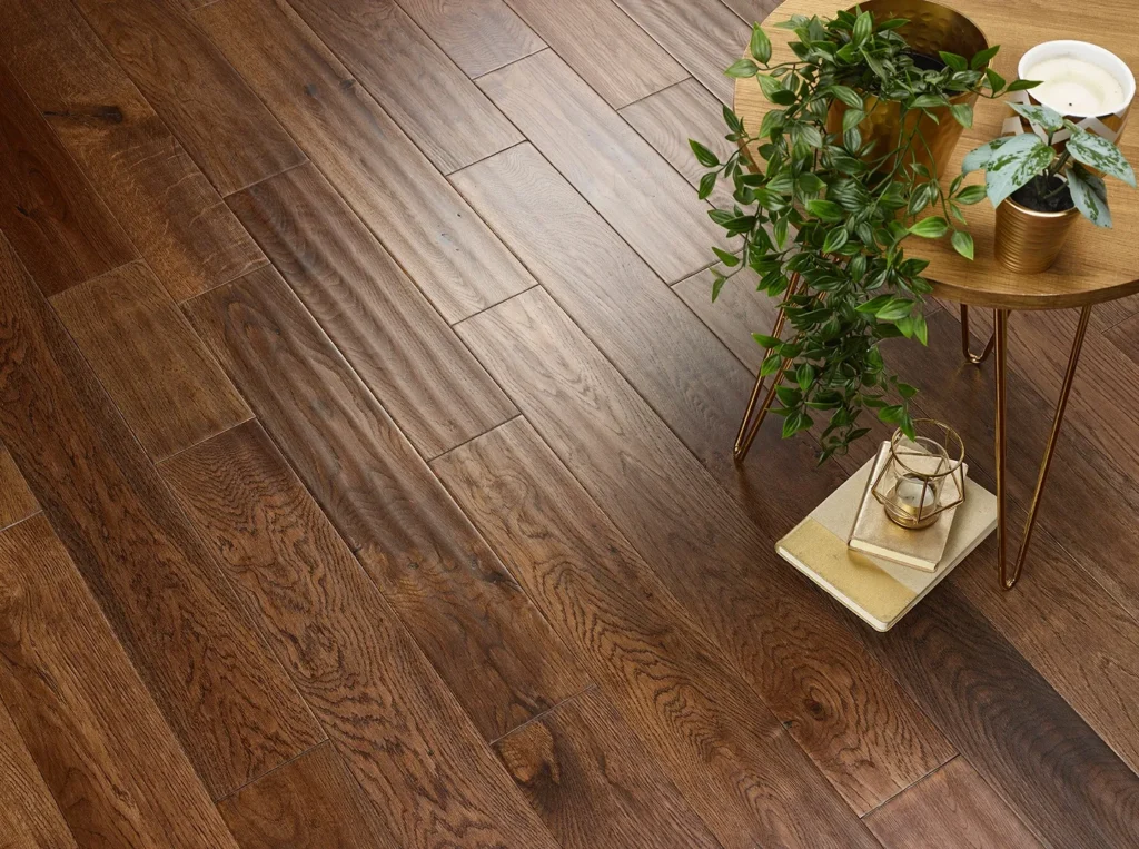 Wooden floor with plants and table decor.