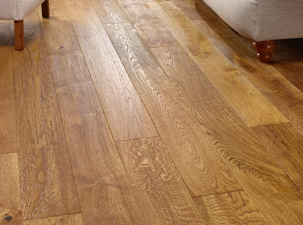 Wooden floor beside beige furniture legs.