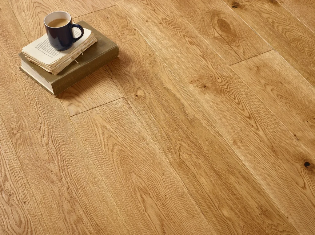 Wooden floor with books and coffee mug.