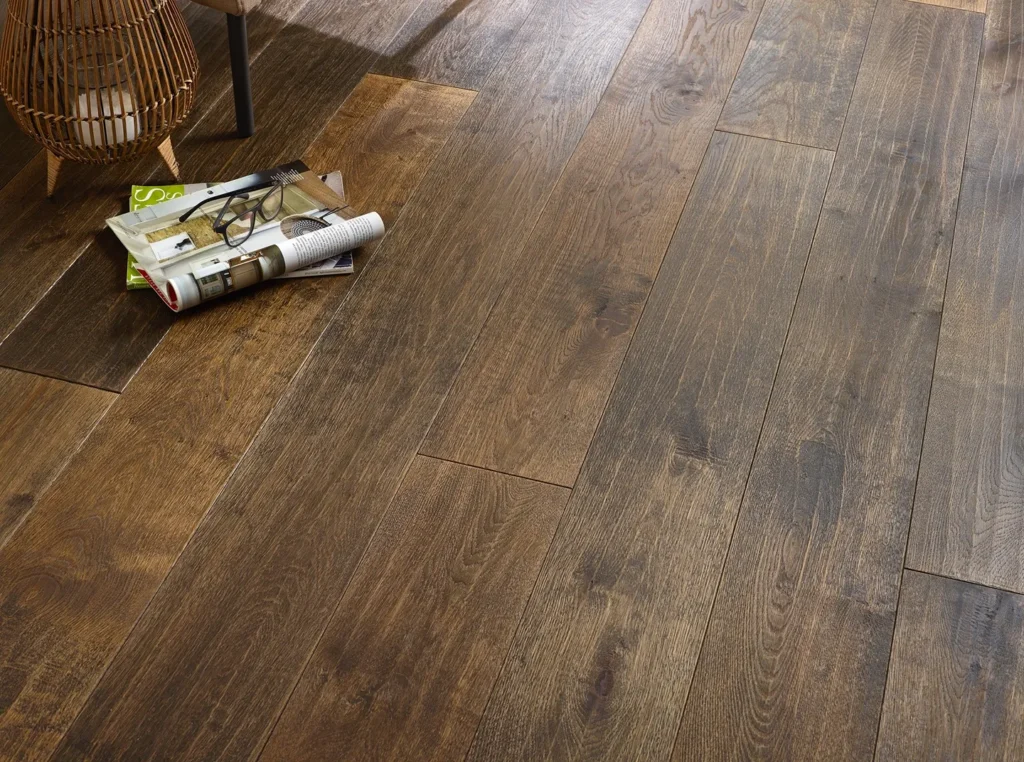 Wooden floor with scattered magazines and glasses.