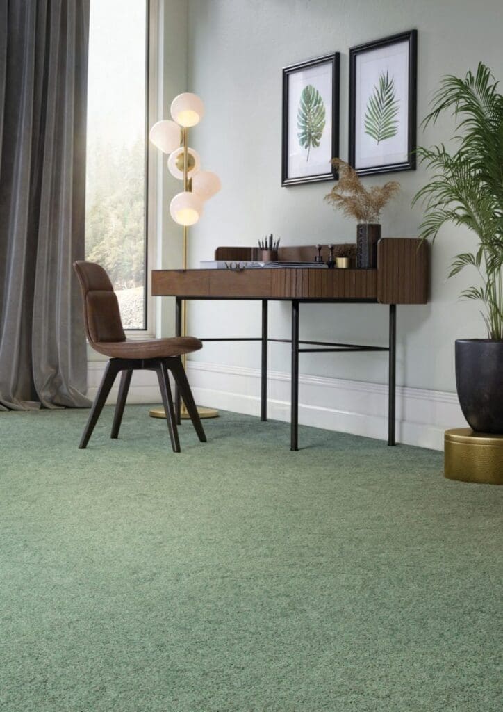 Modern workspace with green carpet and plants.