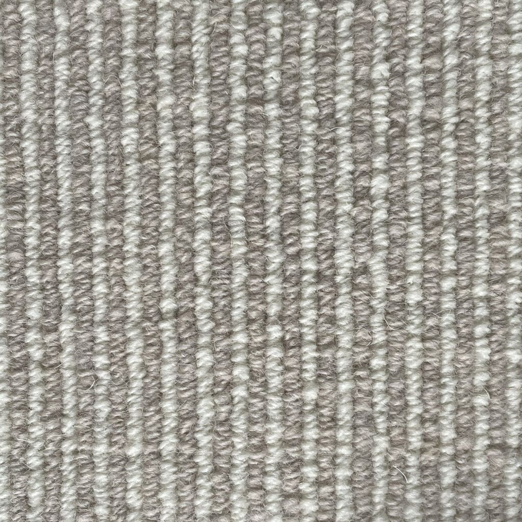 Close-up of a gray textured carpet.