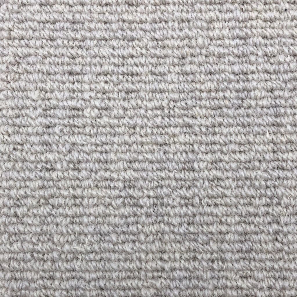 Close-up of light gray textured carpet.