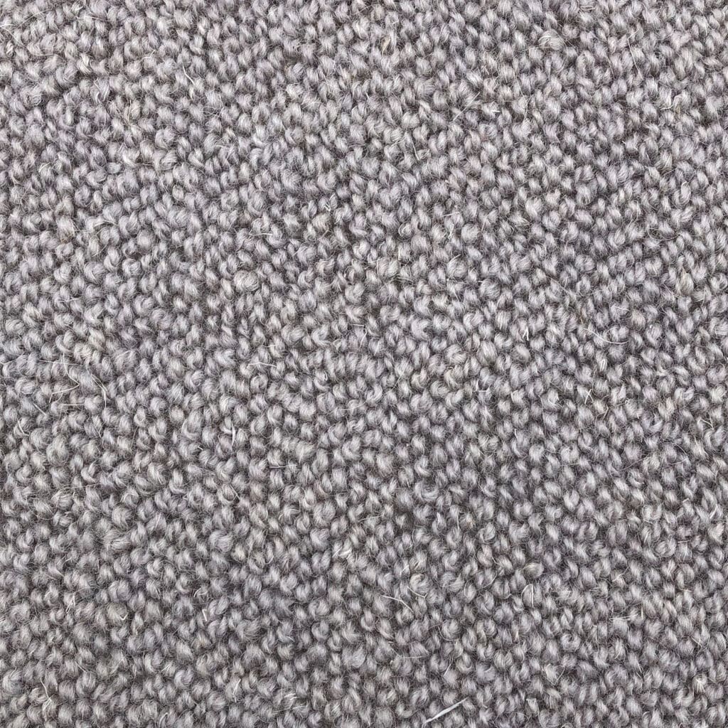 Close-up of beige textured carpet fibers.