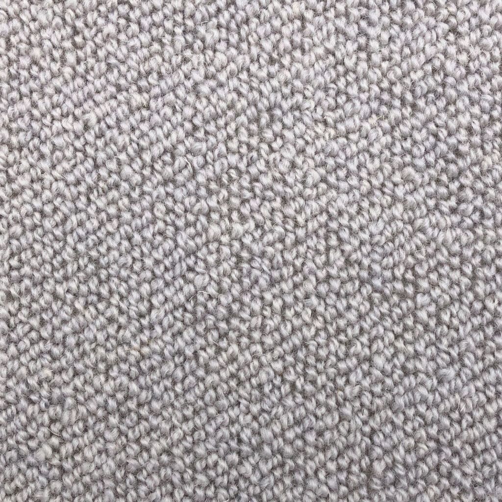 Close-up of textured beige carpet fabric.