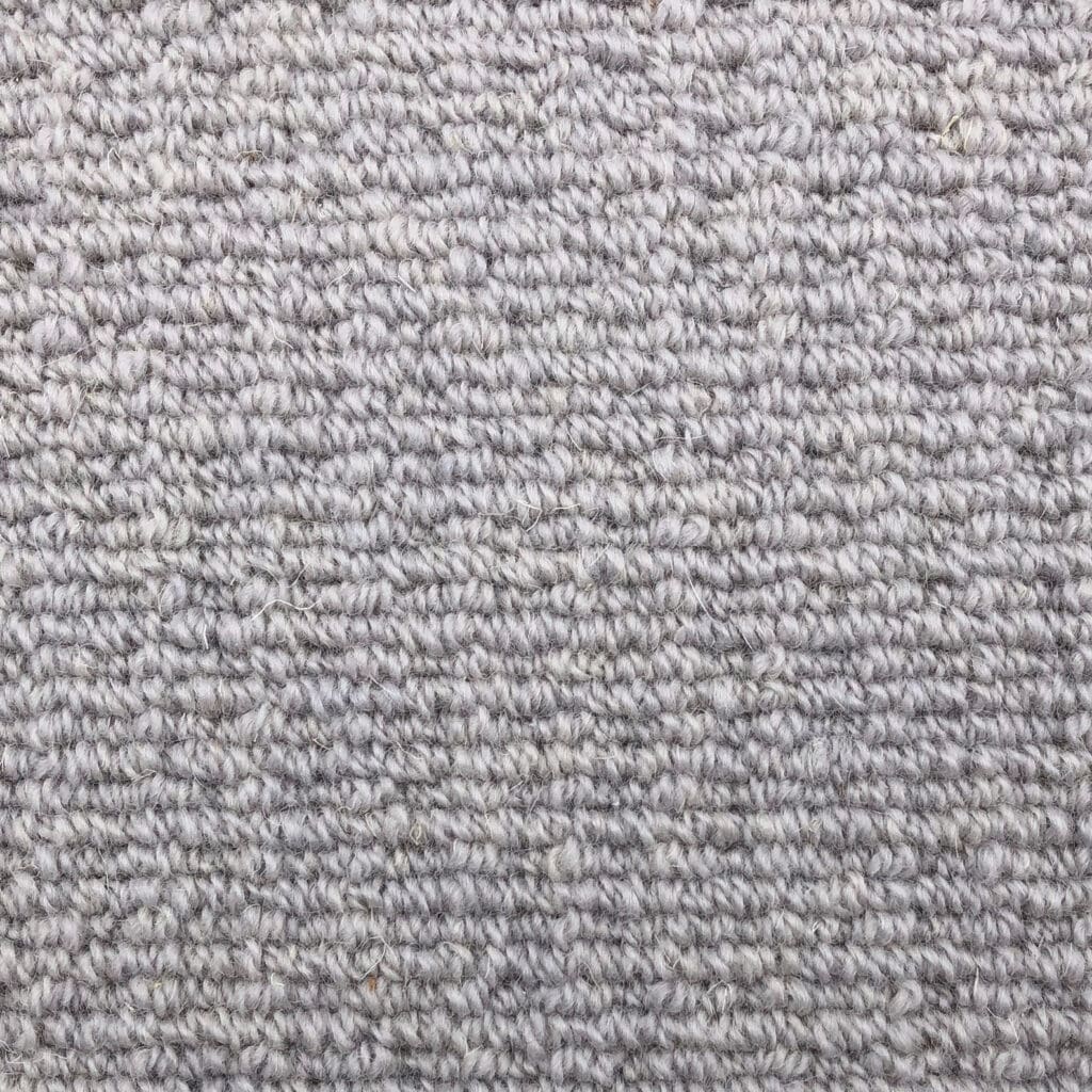 Close-up of gray woven carpet texture.