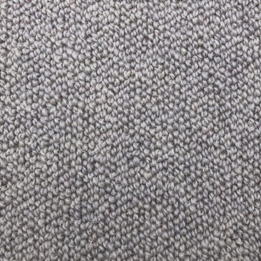Gray textured carpet close-up with tight weave.