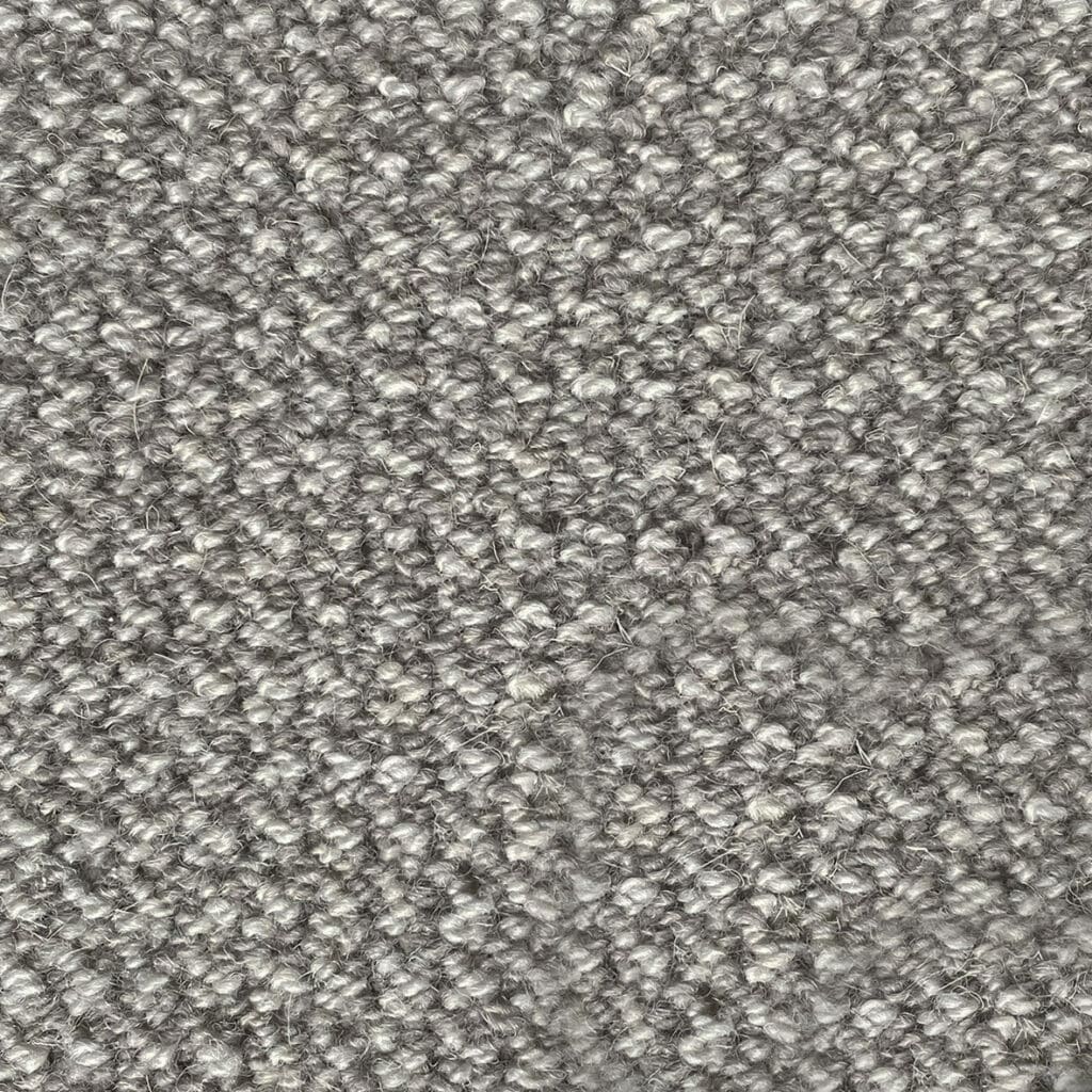 Gray textured wool carpet close-up.