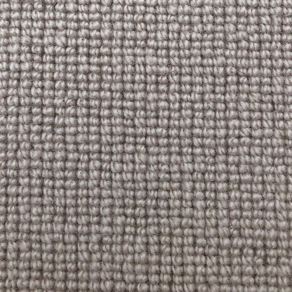 Close-up of beige woven fabric texture.