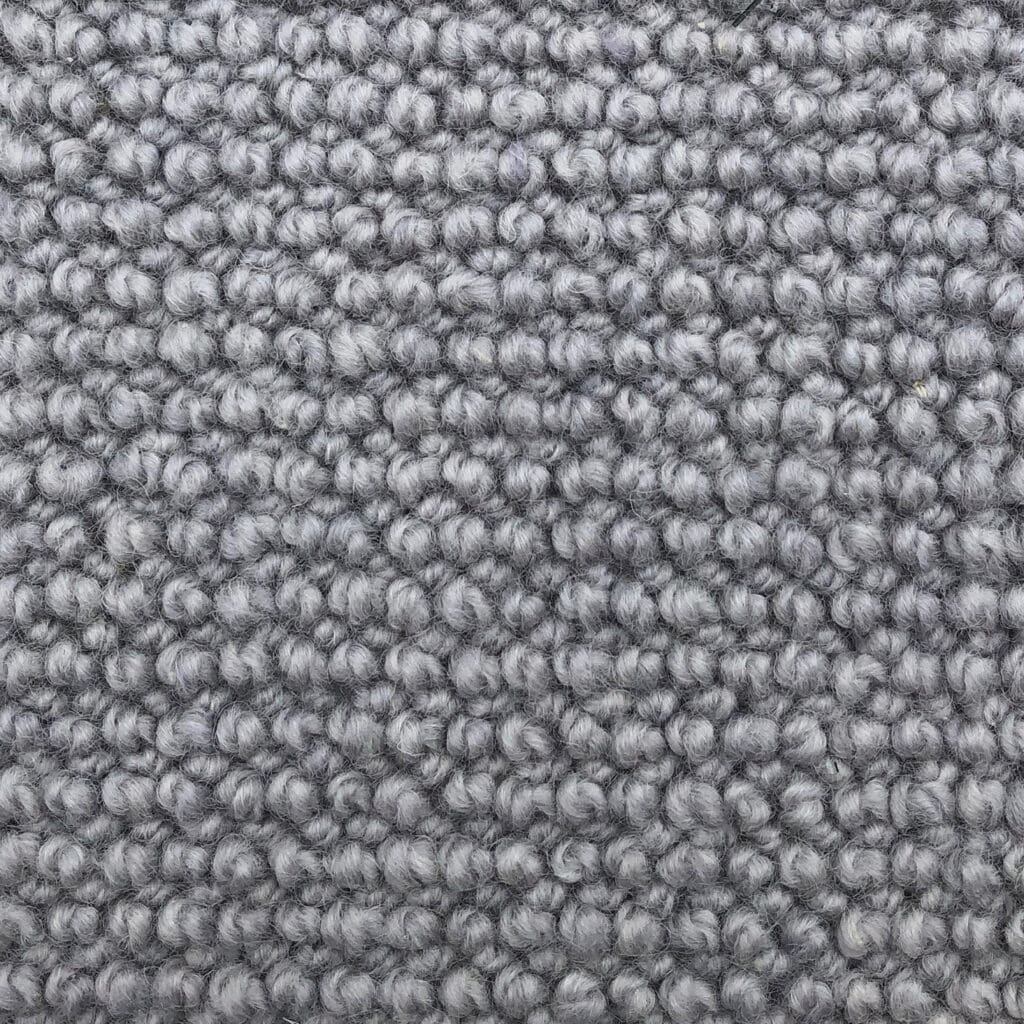 Gray textured carpet with looped fibers.