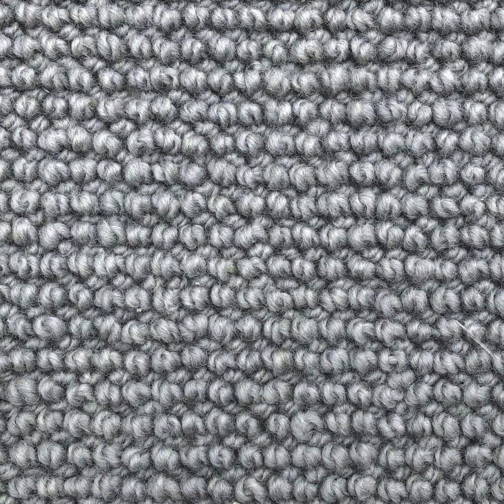 Close-up of textured gray carpet fibers.