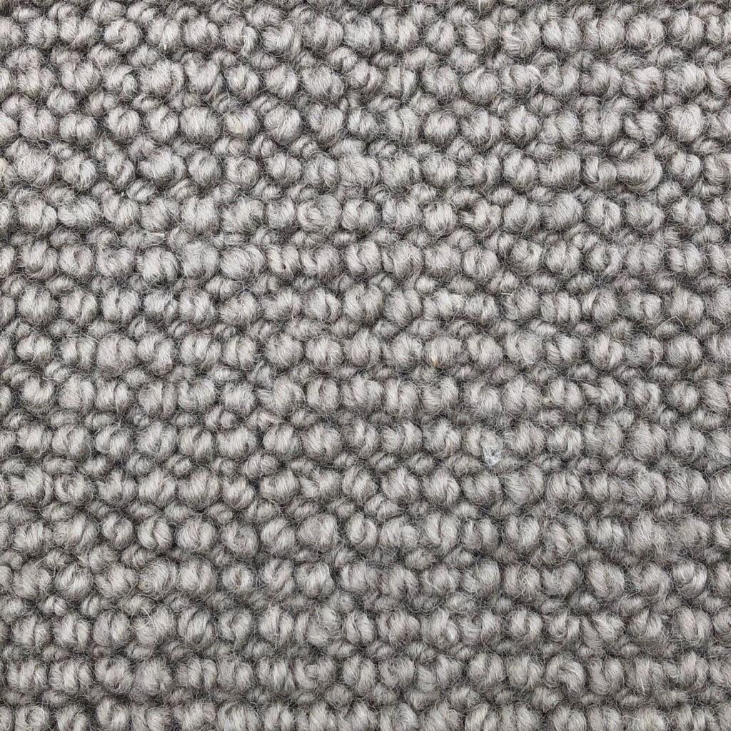 Close-up of textured gray carpet fibers.