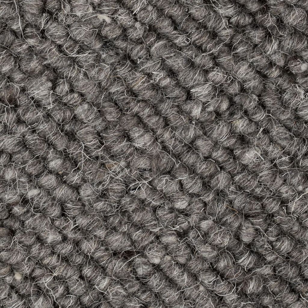 Gray textured wool carpet close-up.