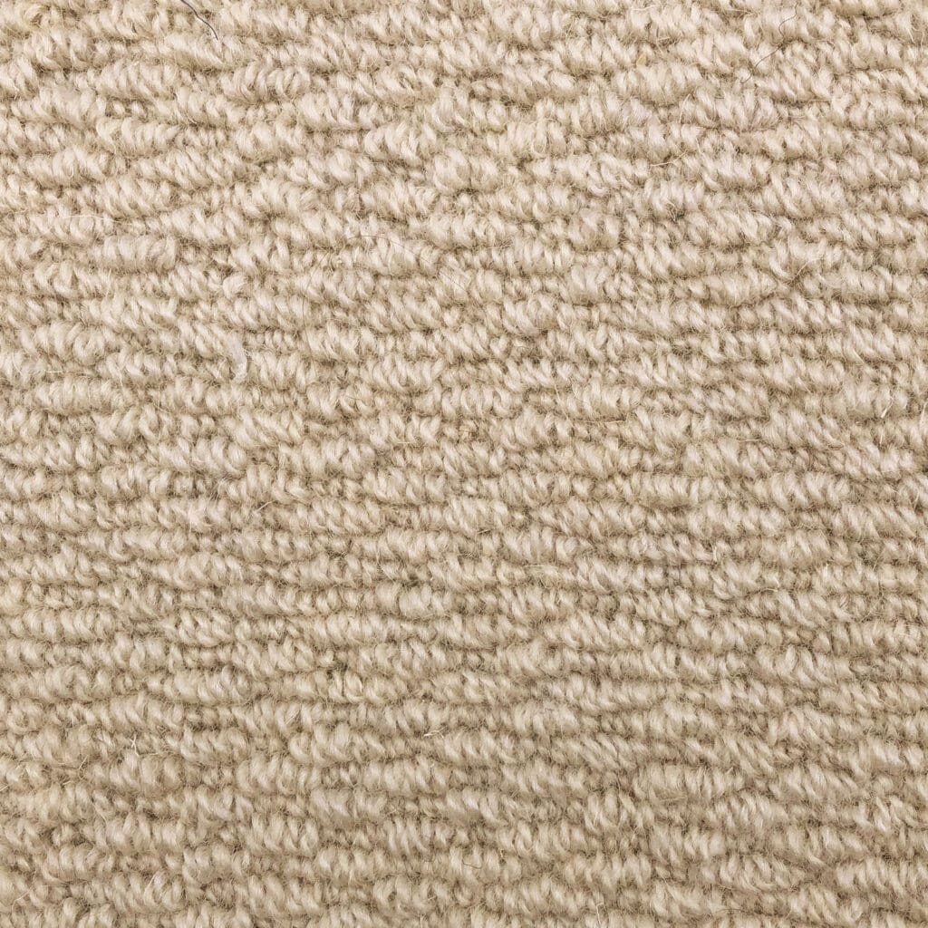 Beige textured carpet with looped pattern.