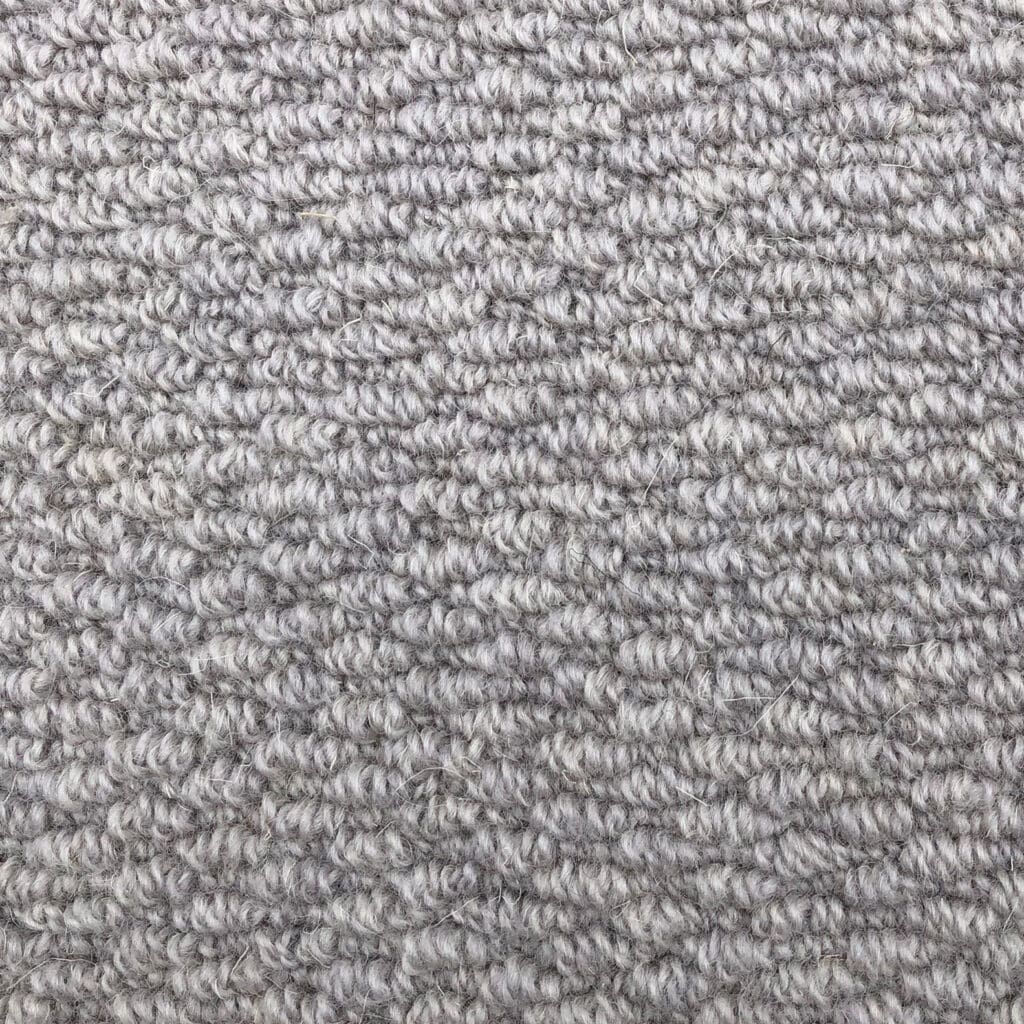 Gray textured carpet close-up pattern view.