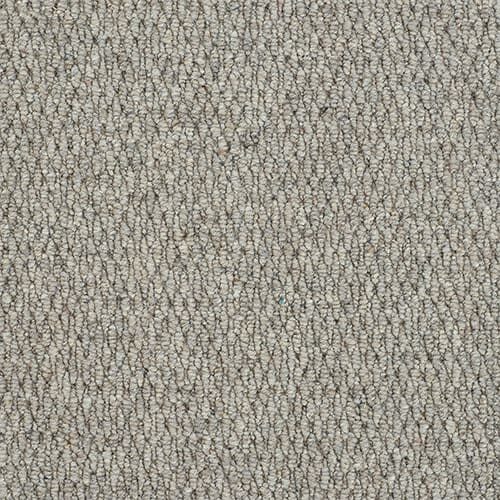 Beige textured carpet with loop pattern.