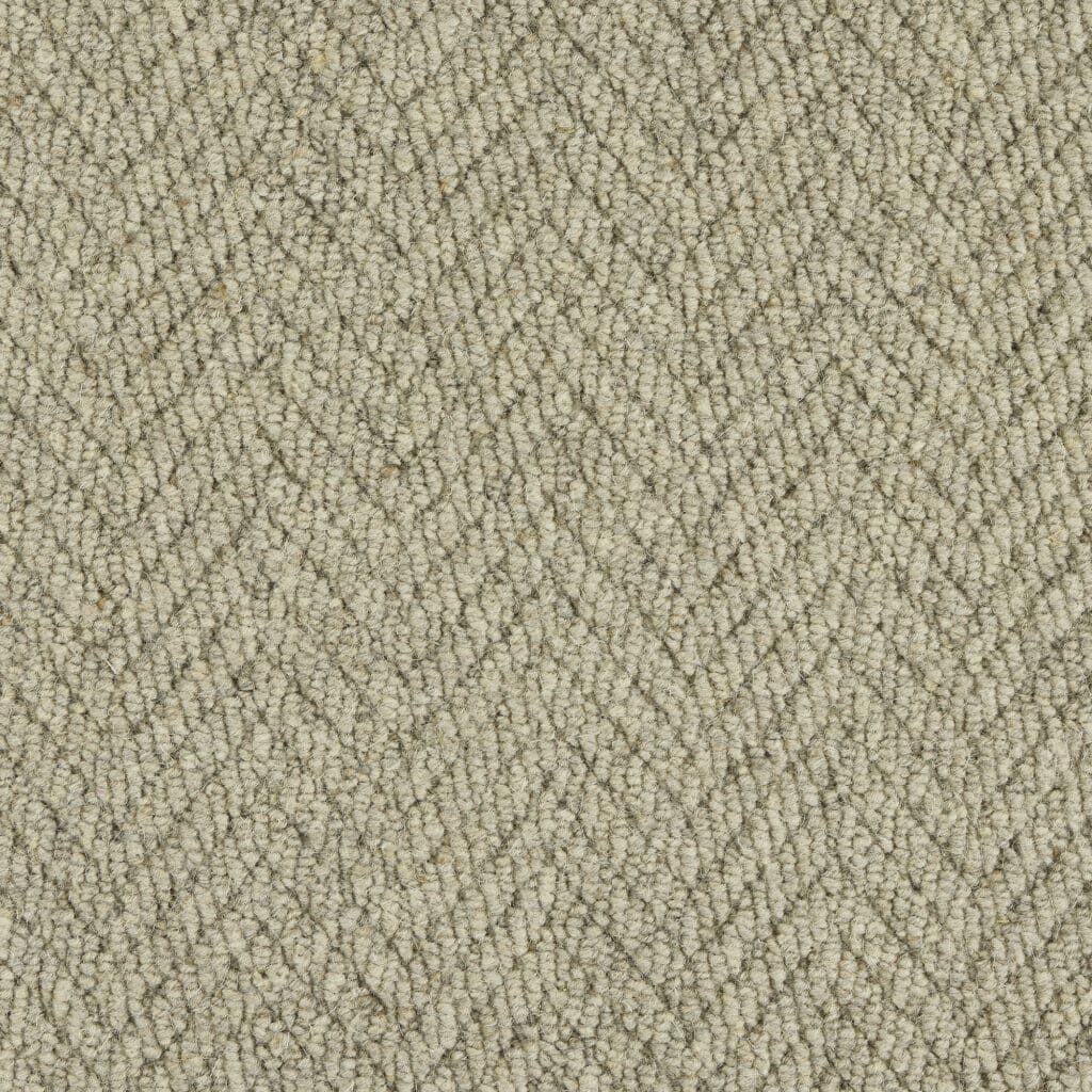 Beige herringbone textured fabric close-up.