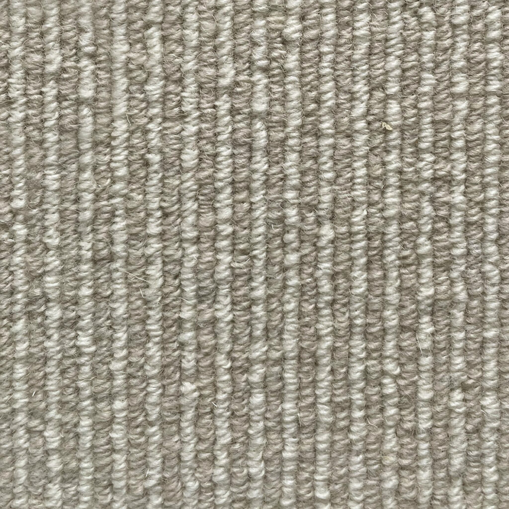 Gray textured carpet with vertical lines.