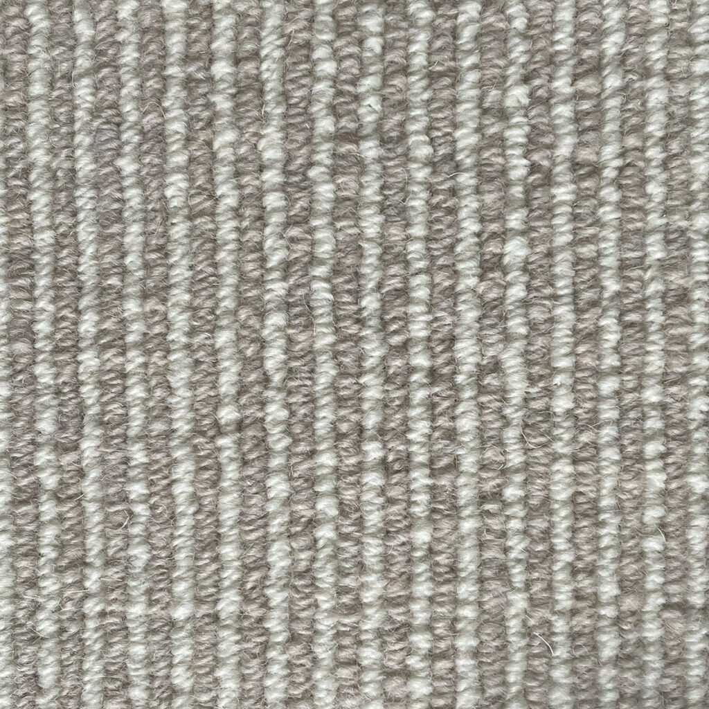 Close-up of a gray textured carpet.