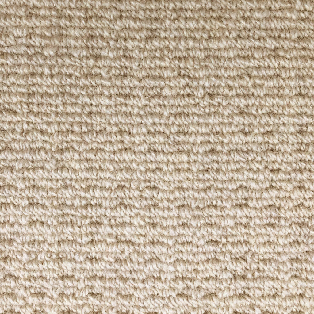 Beige textured carpet close-up view.