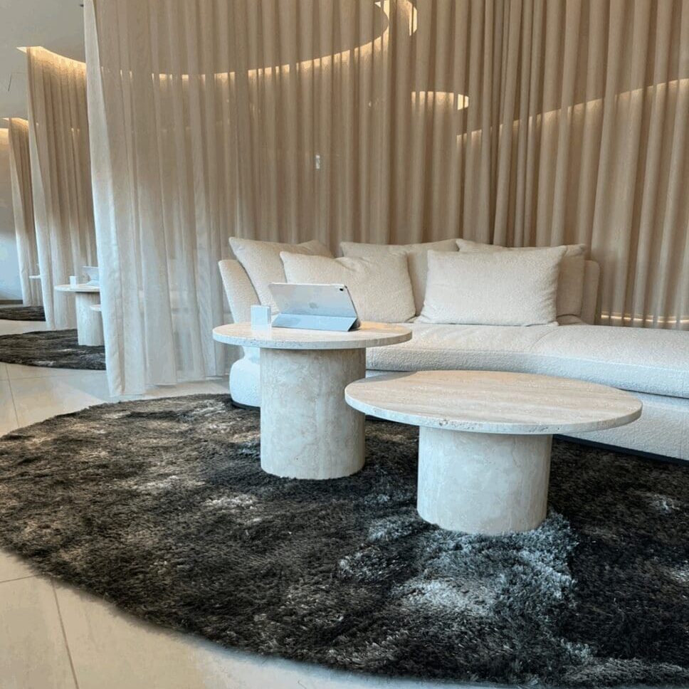 Modern living room with round tables and sofa.