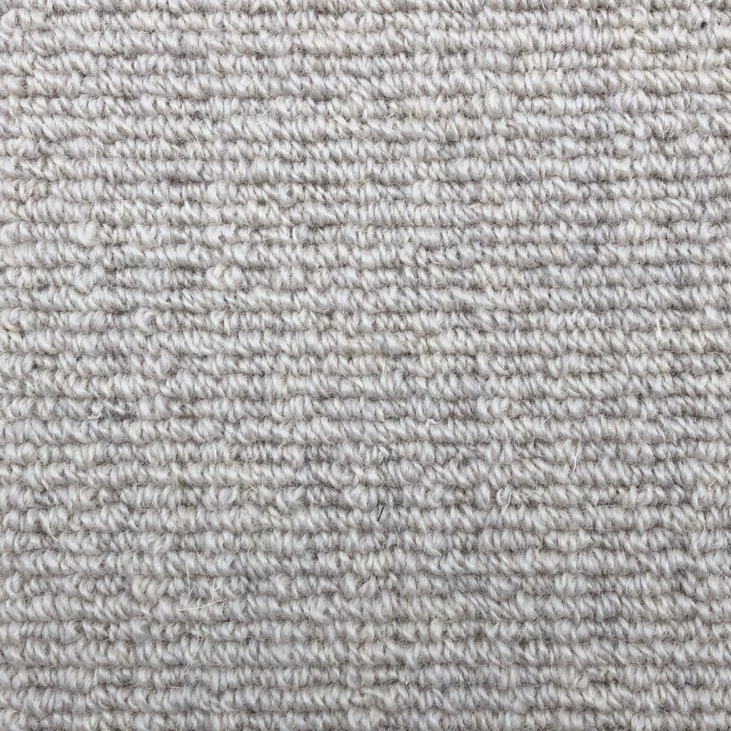 Close-up of light gray textured carpet.