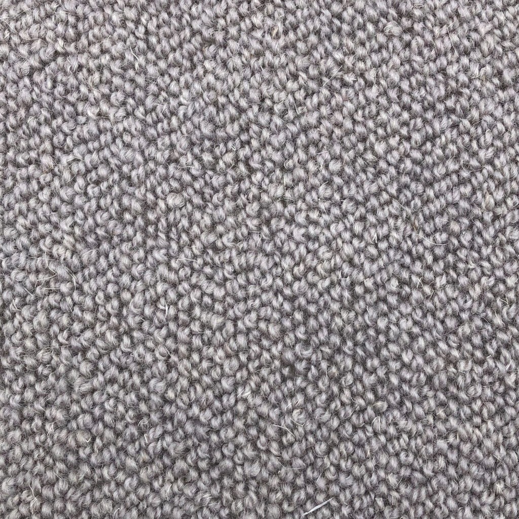 Close-up of beige textured carpet fibers.