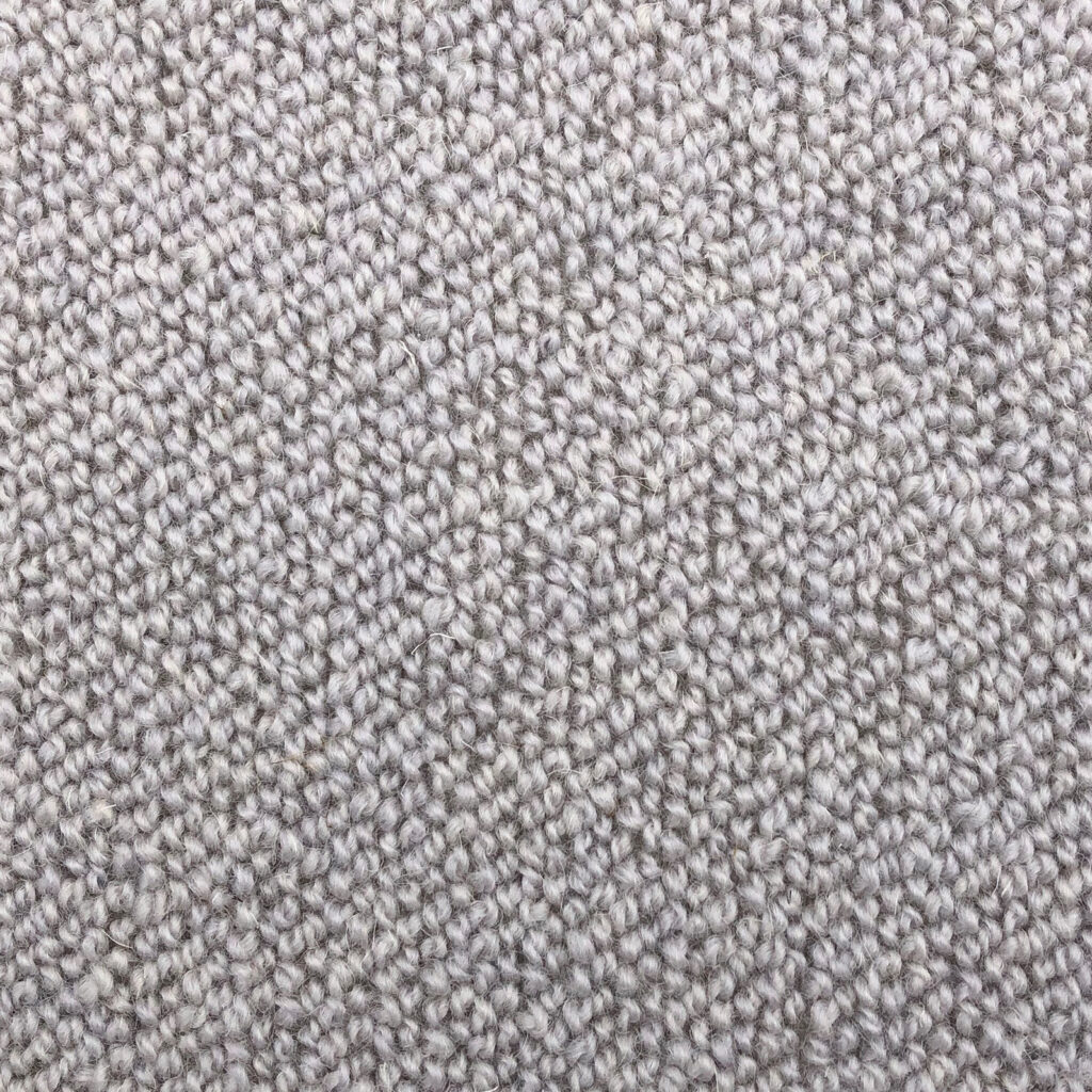 Close-up of textured beige carpet fabric.
