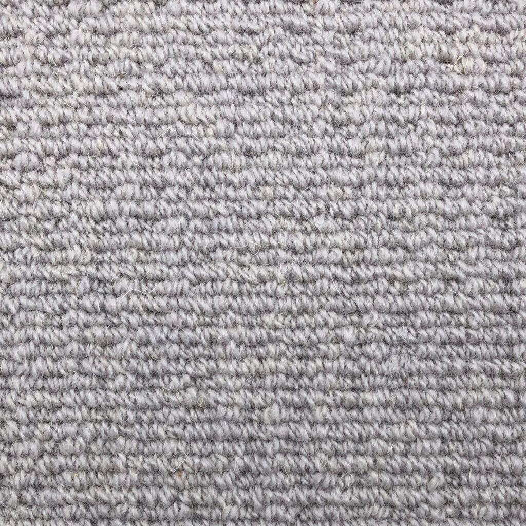 Close-up of gray woven carpet texture.