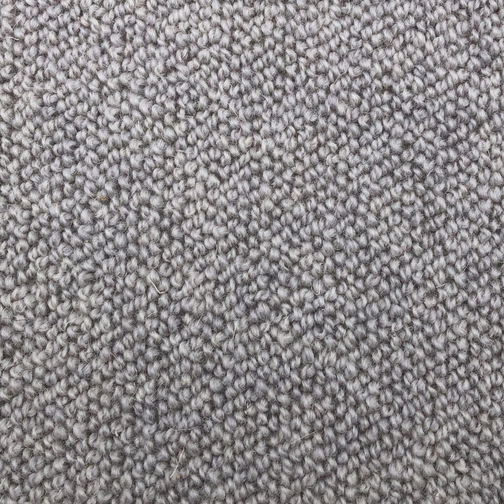 Gray textured carpet close-up with tight weave.