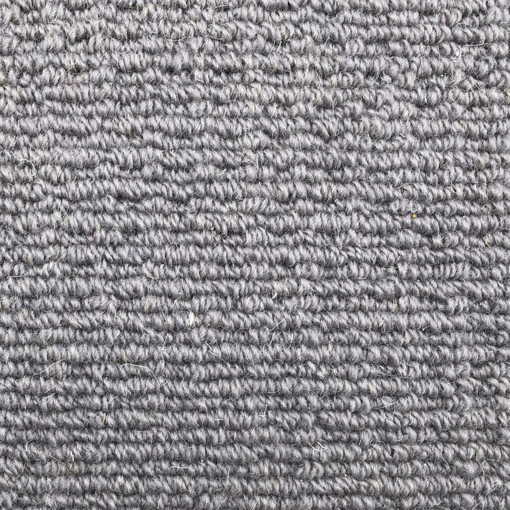 Gray textured carpet with looped pattern.