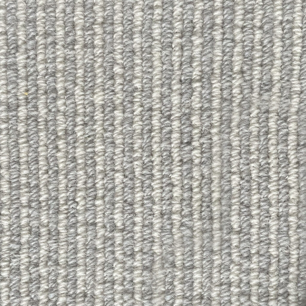 Close-up of textured gray carpet fibers.