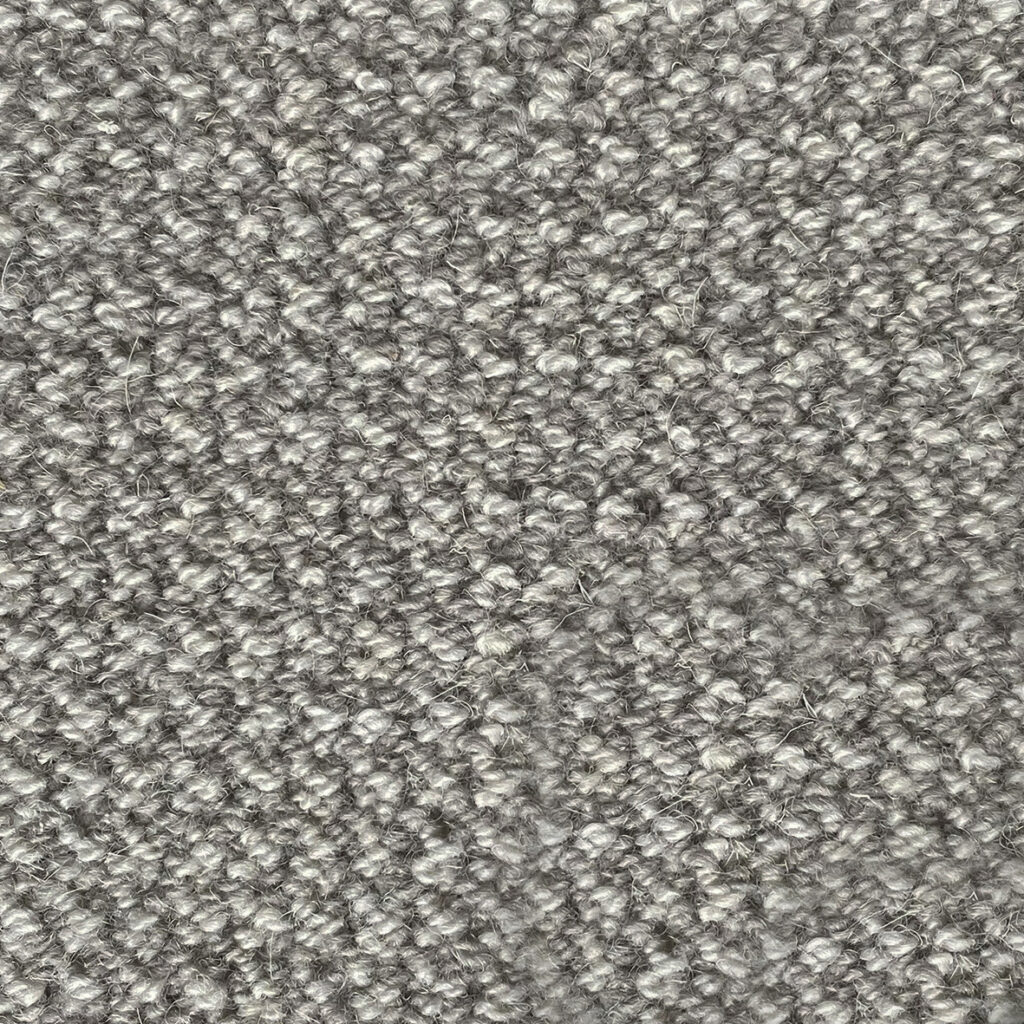 Gray textured wool carpet close-up.