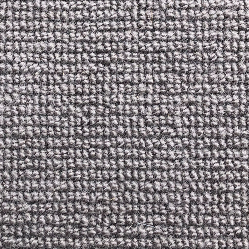 Gray textured carpet fabric close-up.